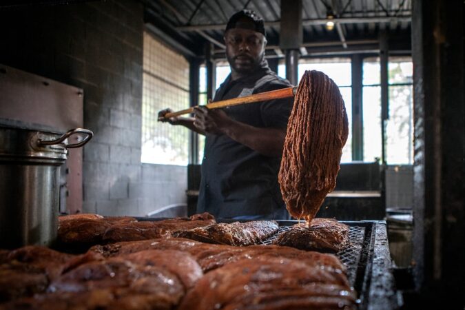 Rodney Scott mops racks of ribs