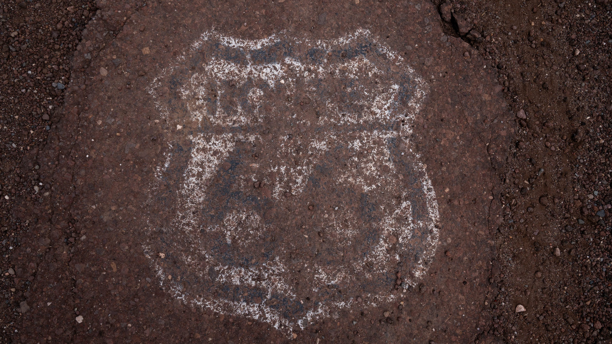 A hand-painted Route 66 sign is seen on the pavement at the historic Partridge Creek Bridge, west of Ash Fork, Arizona, on Aug. 20, 2026.